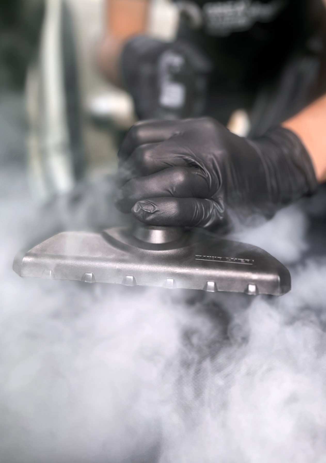 a hand held steam cleaner with lots of steam